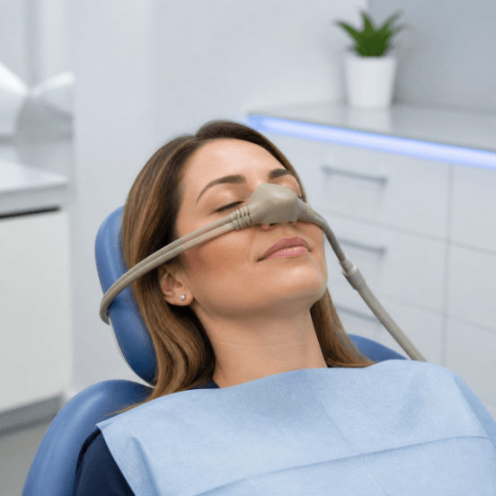 Relaxed patient receiving nitrous oxide through a small nasal hood