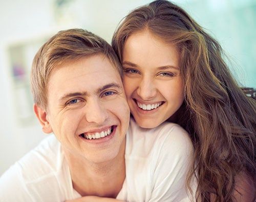 Happy couple after successful implant treatment