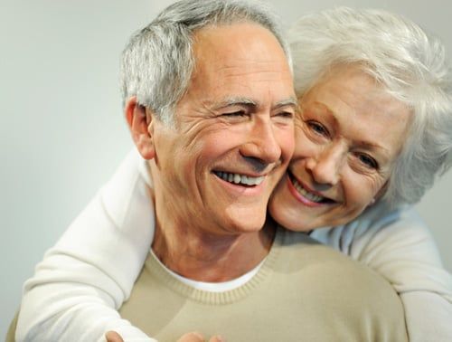 Smiling senior couple enjoying the benefits of dental implants