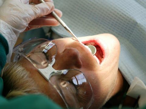 Dentist looking in a woman’s mouth